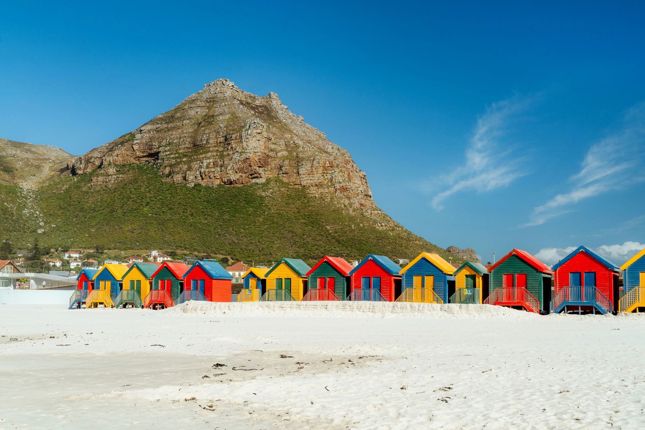 Cape Town beach with colorful huts and mountain backdrop